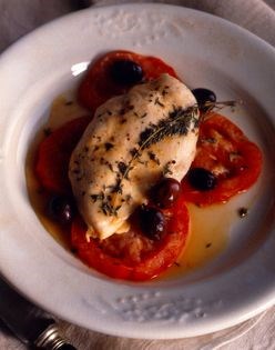 Chicken breasts in foil with tomato, olives, and Parmesan