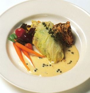 Chicken breasts steamed in cabbage with cider cream sauce