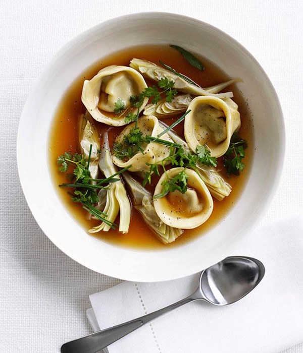 Chicken brodo with artichoke tortellini and spring herbs