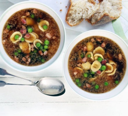Chicken broth with orecchiette, pancetta and peas