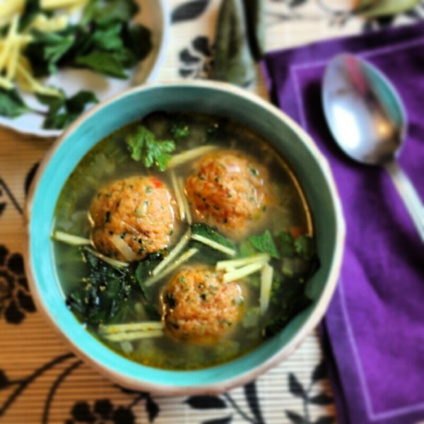 Chicken broth with prawn and chorizo meatballs and herbs