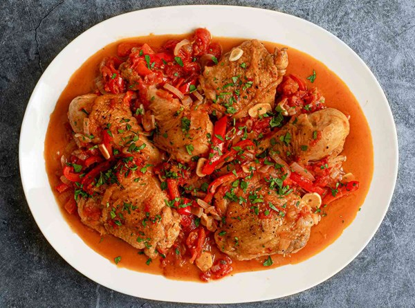 Chicken cacciatore with red peppers, tomato, and onion