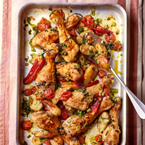 Chicken drumsticks roasted with cherry tomatoes, spring onions, sage and red chilli