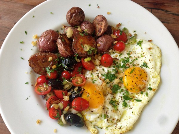 Chicken fat potatoes, fried eggs and tomato olive salsa