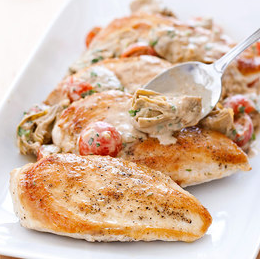 Chicken in creamy Parmesan sauce with artichokes and tomatoes