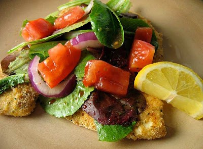 Chicken Milanese with arugula and tomatoes
