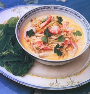Chicken noodle hotpot with coconut milk and fresh leaves