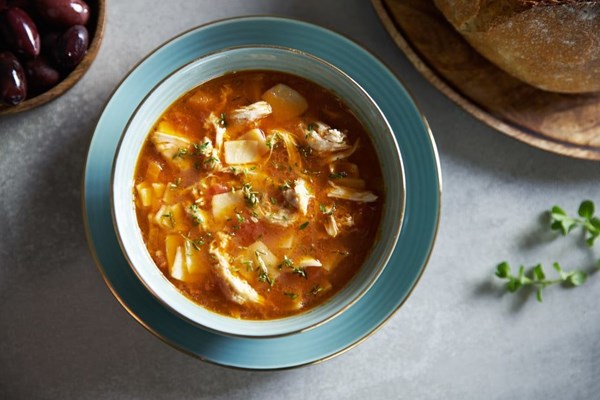 Chicken noodle soup with fresh pasta, tomatoes, and grated cheese (Kokoras protoyiahni)
