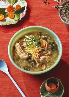 Chicken rice porridge with saffron, collards, and soy-cured egg yolks (Arroz caldo)