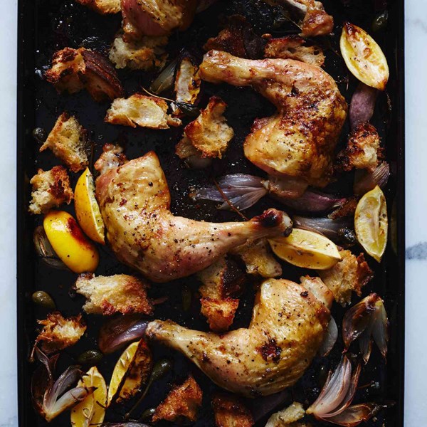 Chicken roasted on bread with caperberries and charred lemons
