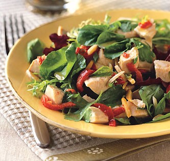 Chicken salad with piquillo peppers, almonds, and spicy greens