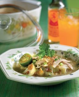 Chicken shreds and rice cubes in spicy chicken broth (Soto ayam)