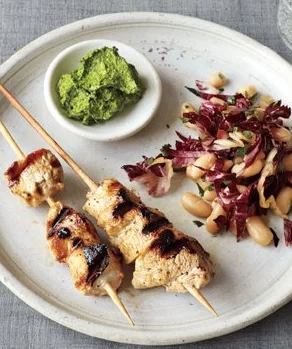 Chicken skewers with bean salad and parsley pesto
