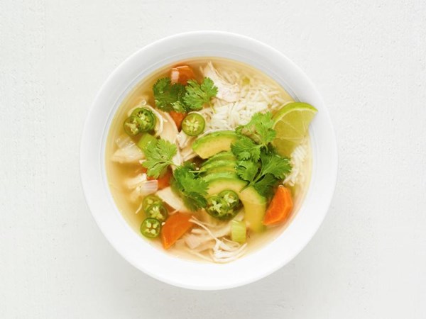 Chicken soup with rice, avocado and lime 