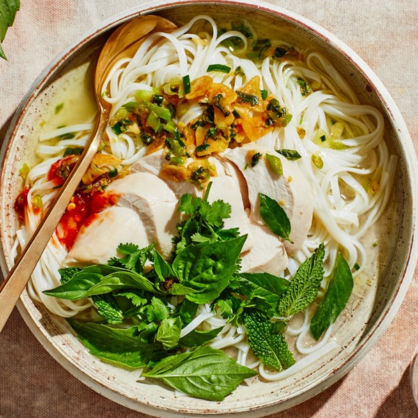 Chicken soup with rice noodles and scallion crisp