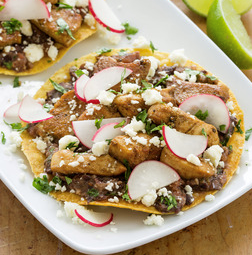 Chicken tostadas with spicy mashed black beans