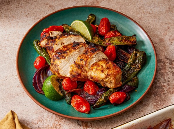 Chicken traybake with poblano chilies, tomatoes and onions