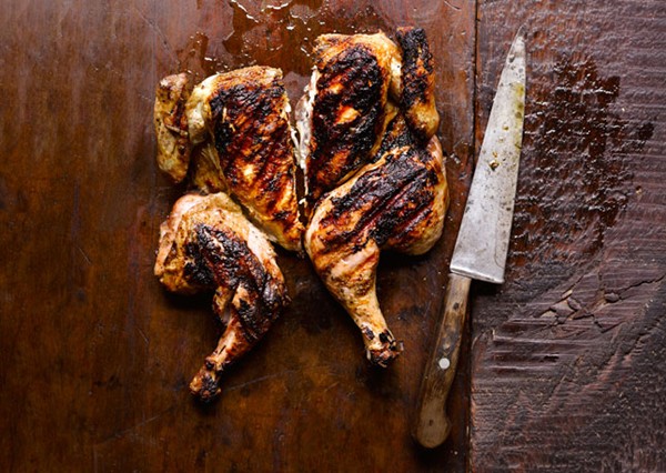 Chicken under a brick