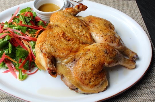 Chicken under a brick