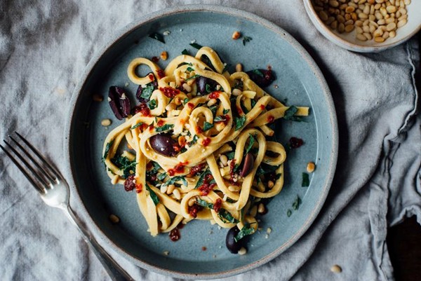 Chickpea fettuccine with harissa, kale, and olives