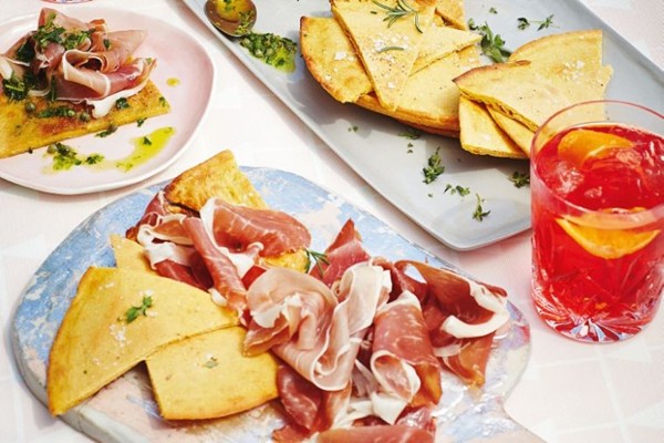 Chickpea flatbread with prosciutto and herb sauce