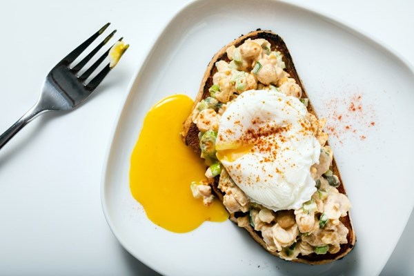 Chickpea salad toasts with poached egg