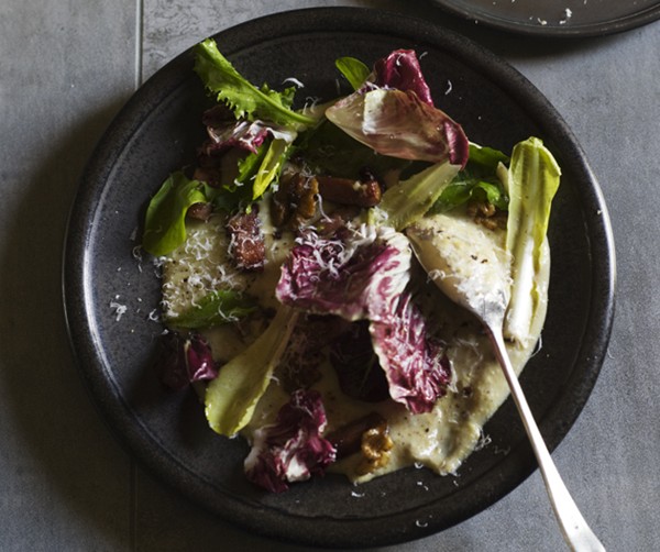 Chicory and bacon on wet polenta with walnuts