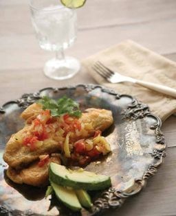 Chile rellenos topped with ranchero sauce (Chile rellenos con salsa ranchera)