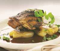Chili-rubbed chicken thighs with smashed grilled potatoes and mole sauce