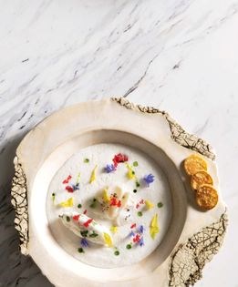 Chilled bacalao soup with celery leaves, potato pancakes, and hyssop "oeufs à la neige"