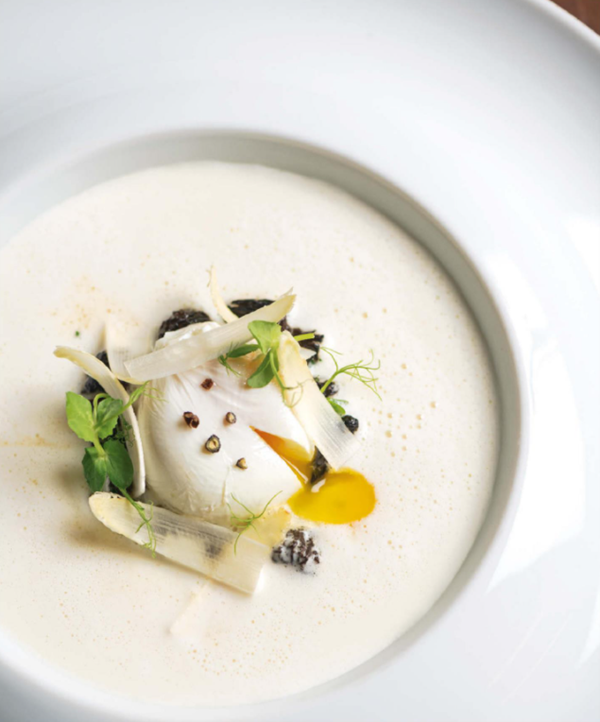 Chilled white asparagus soup with poached egg and morels