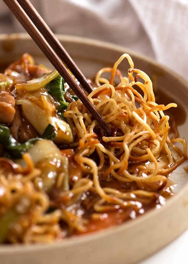 Chinese crispy noodles with saucy chicken and vegetables (Chow mein)