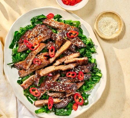 Chinese-style BBQ pork with sesame summer greens