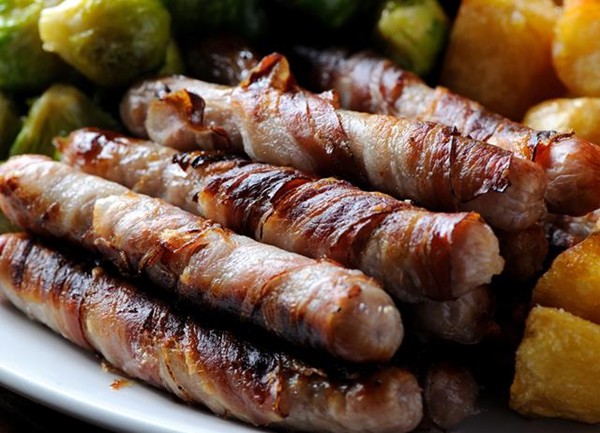 Chipolatas wrapped in streaky bacon