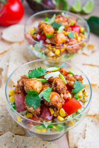 Chipotle lime shrimp and guacamole dip with tomatoes and charred corn
