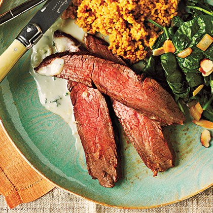 Chipotle-rubbed flank steak with couscous and spinach with toasted almonds