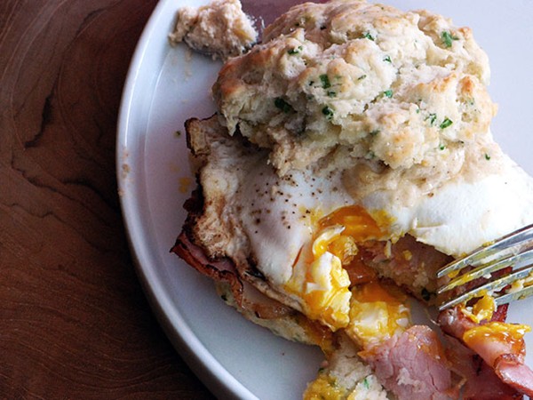 Chive biscuit sandwich with cheddar spread, Canadian bacon, and a fried egg