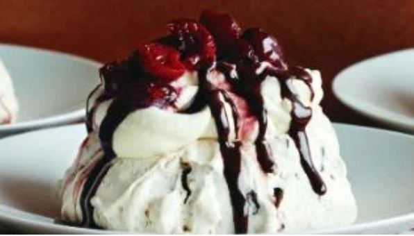 Chocolate and almond Pavlovas with cherry and chocolate sauces