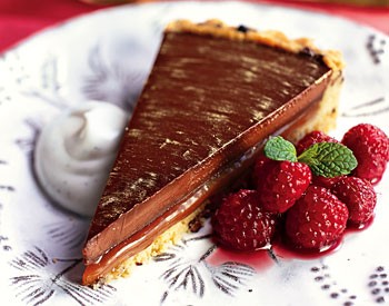 Chocolate-caramel tart with drunken raspberries and vanilla crème fraîche