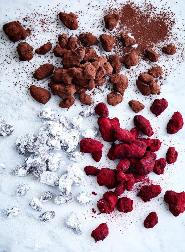 Chocolate coated candied nuts with plum powder and cocoa