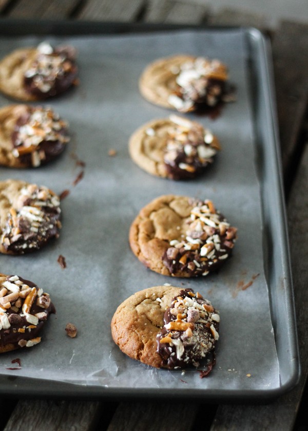 Chocolate-dipped peanut butter cookies with toffee & crushed pretzels