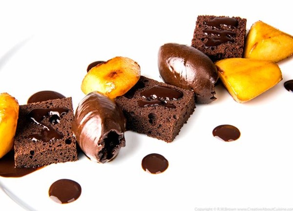 Chocolate genoise with dark chocolate ganache, caramelised pear and cocoa syrup