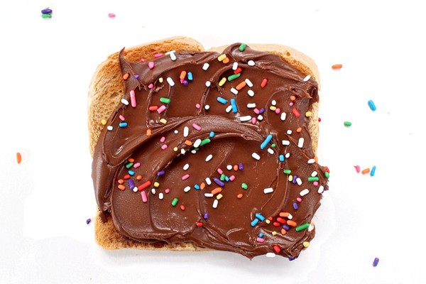Chocolate hazelnut spread with rainbow jimmies on white toast