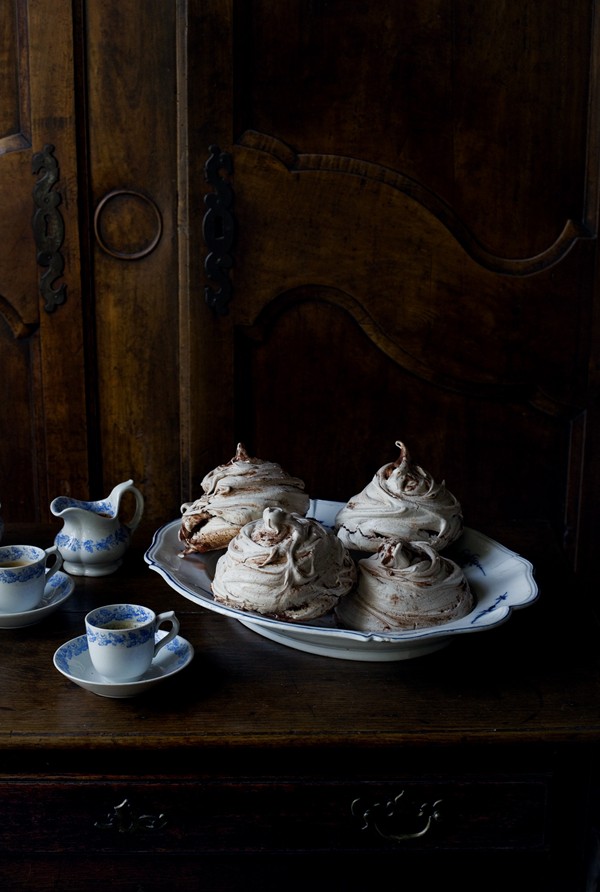 Chocolate meringue swirls with chocolate sauce with crème Chantilly