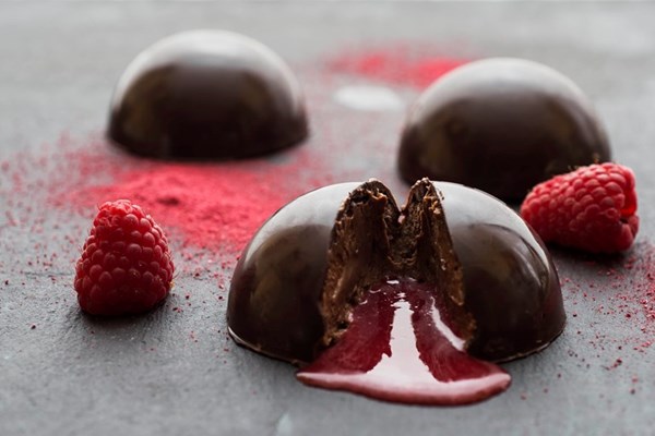  Chocolate mousse domes with raspberry coulis centre