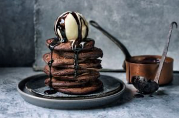 Chocolate pancakes with chocolate fudge sauce