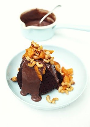 Chocolate pudding with mandarins, cashews and milk chocolate sauce