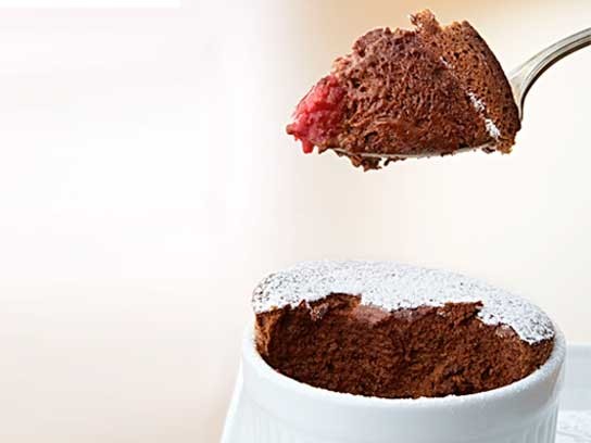 Chocolate soufflés with raspberries