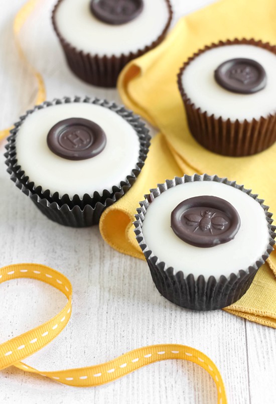 Chocolate "wax" seals on poured fondant honey cupcakes