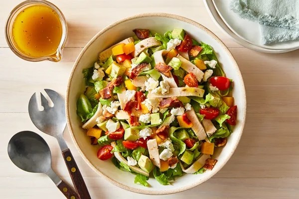 Chopped salad with chicken, peach and crumbled feta